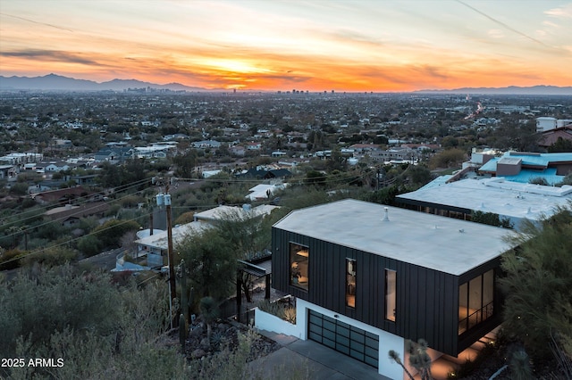 aerial view at dusk featuring a mountain view