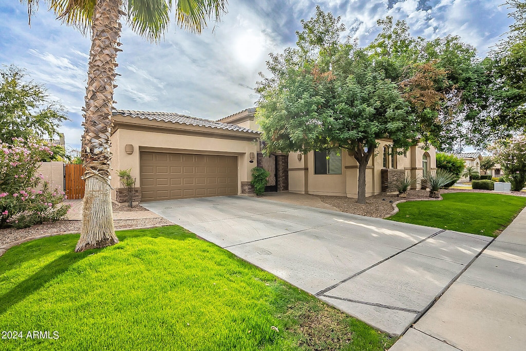 view of front of property featuring a front yard and a garage