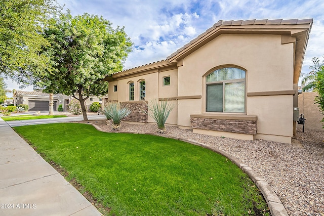 mediterranean / spanish house with a front yard