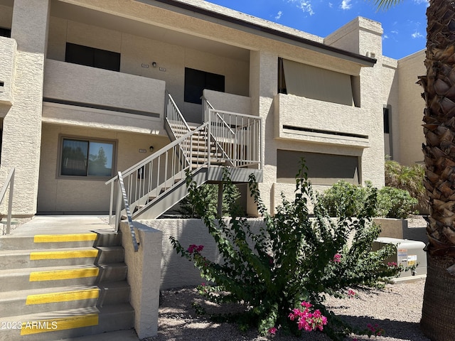 doorway to property featuring stucco siding