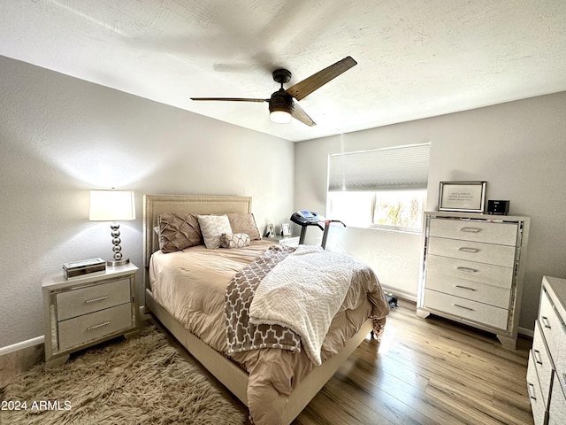 bedroom featuring baseboards, ceiling fan, and hardwood / wood-style flooring