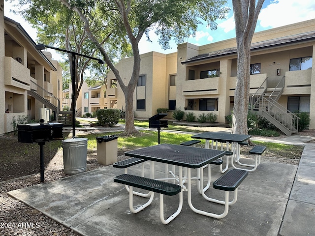 surrounding community with stairway and a patio area