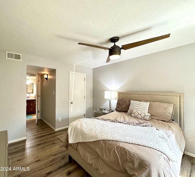 bedroom featuring baseboards, visible vents, a ceiling fan, and wood finished floors