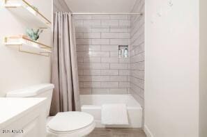 full bathroom featuring toilet, vanity, and shower / bath combination with curtain