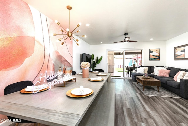 dining space with dark wood-type flooring and ceiling fan with notable chandelier