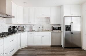 kitchen with stainless steel appliances, white cabinets, sink, and dark wood-type flooring