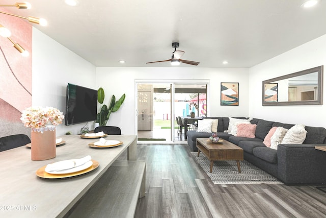 living room featuring ceiling fan and dark wood-type flooring