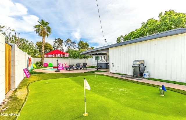 view of yard with a hot tub and a patio