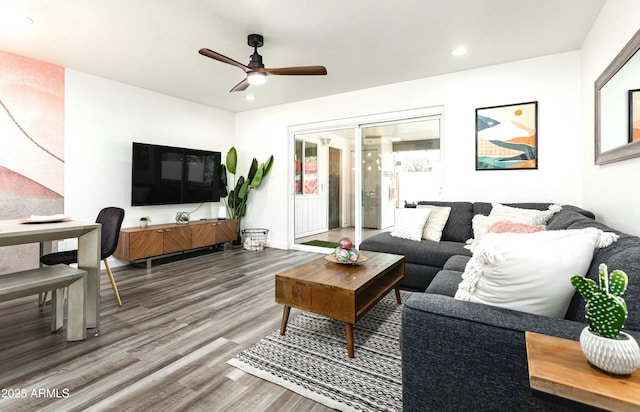 living room featuring ceiling fan and hardwood / wood-style flooring