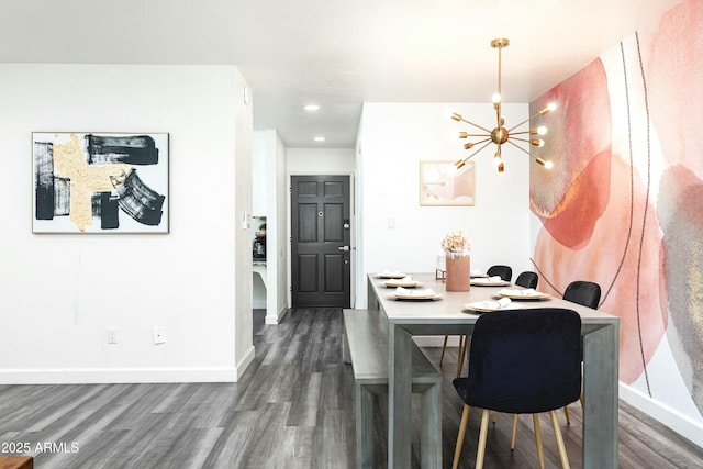 dining area featuring dark hardwood / wood-style flooring and a chandelier