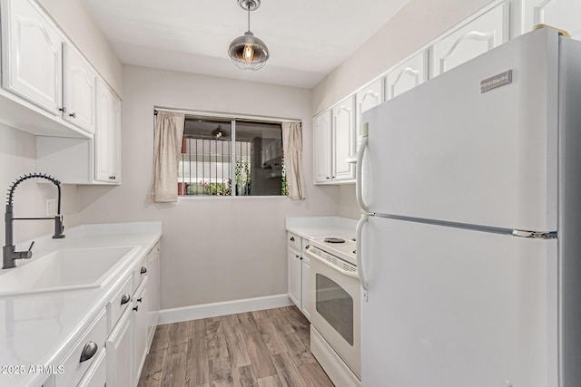 1650 N 87th Ter Unit 25A, Scottsdale, AZ 85257 - kitchen featuring white appliances, white cabinets, light wood-type flooring, light countertops, and hanging light fixtures
