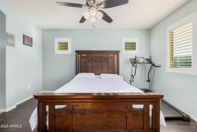 bedroom featuring dark wood-style floors, baseboards, and a ceiling fan