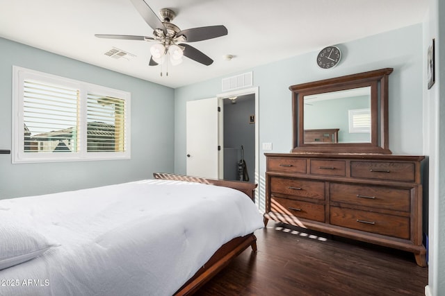 bedroom with a ceiling fan, dark wood-style flooring, and visible vents