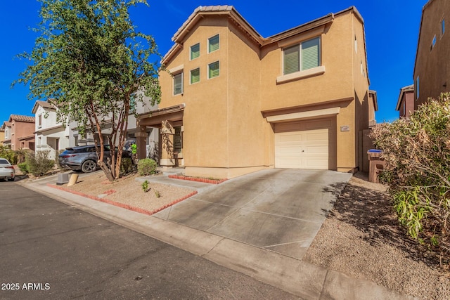 view of front of property with a garage, concrete driveway, a residential view, and stucco siding