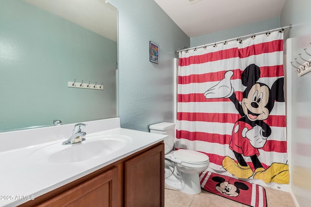 full bathroom featuring a shower with curtain, vanity, toilet, and tile patterned floors