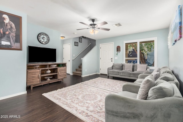 living room featuring baseboards, visible vents, dark wood finished floors, a ceiling fan, and stairway