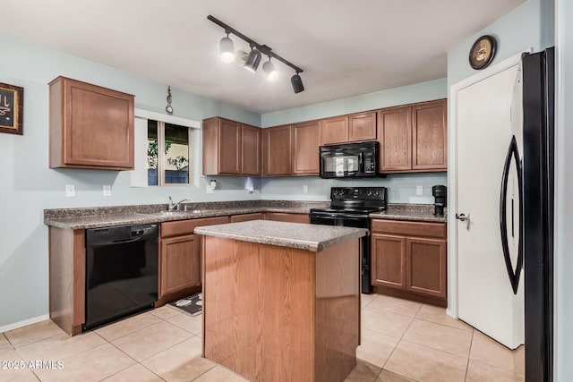 kitchen with brown cabinets, light tile patterned floors, a kitchen island, a sink, and black appliances