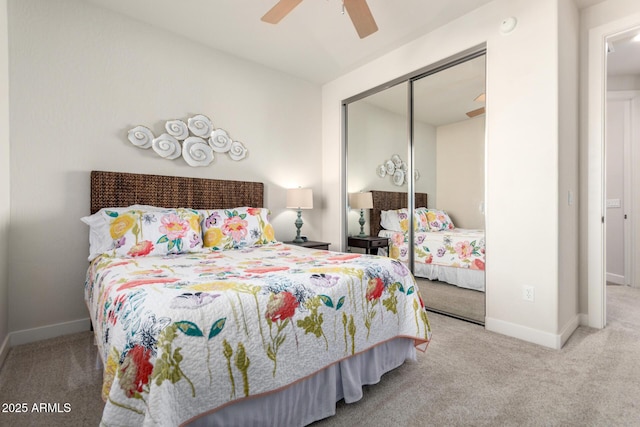 carpeted bedroom featuring ceiling fan and a closet