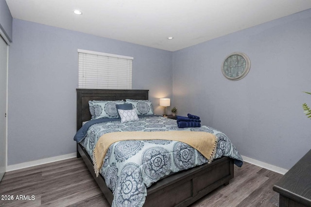 bedroom with dark hardwood / wood-style floors