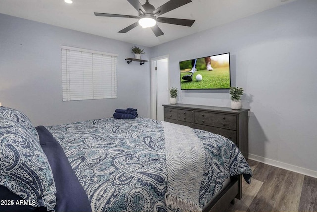 bedroom with ceiling fan and dark hardwood / wood-style floors