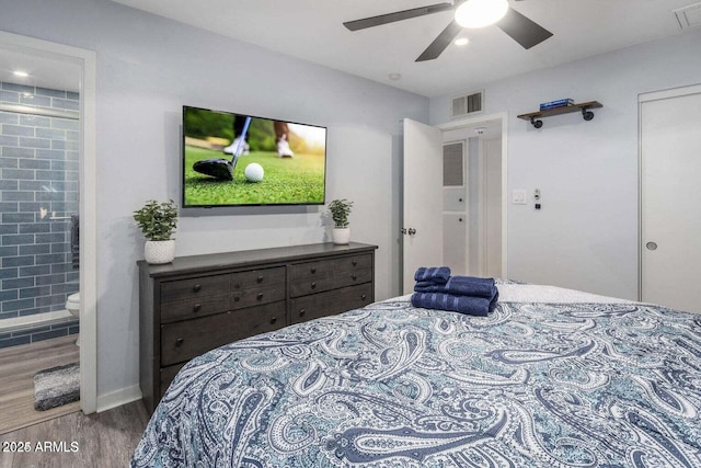 bedroom featuring connected bathroom, ceiling fan, and wood-type flooring