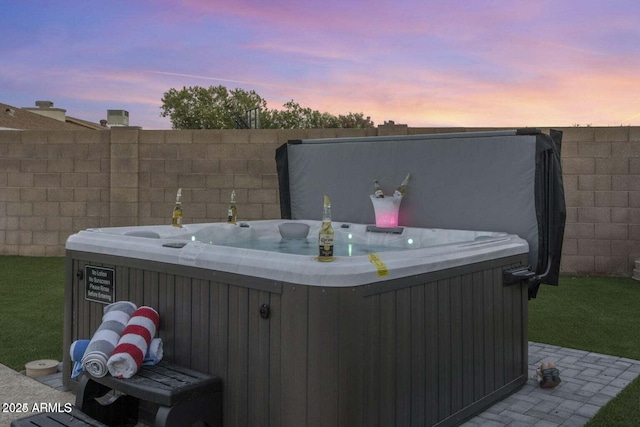 patio terrace at dusk with a hot tub