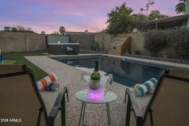 view of pool at dusk