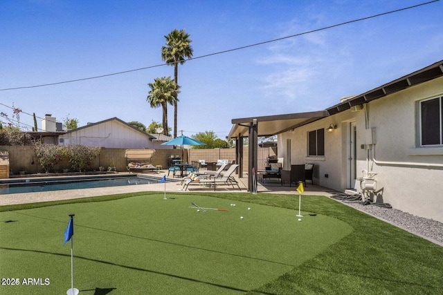 view of home's community with a swimming pool and a patio