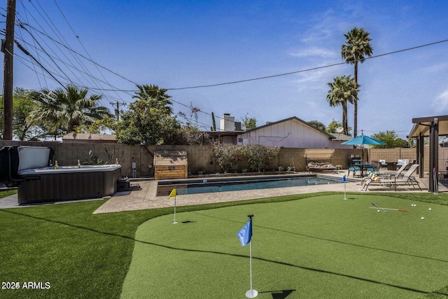 exterior space featuring a swimming pool with hot tub and a patio