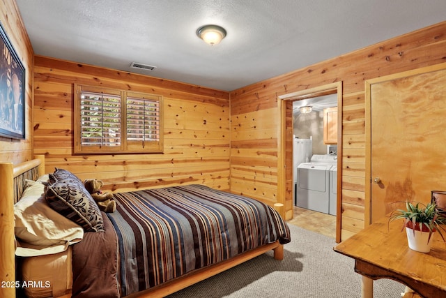 1868 Flicker Dr, Forest Lakes, AZ 85931 - bedroom with separate washer and dryer, wood walls, light carpet, a textured ceiling, and ensuite bath