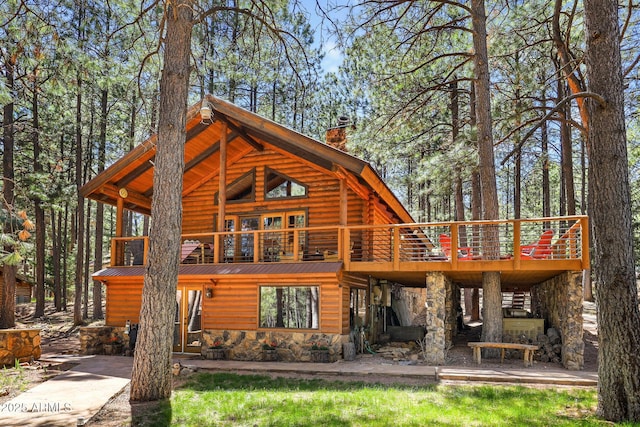 1868 Flicker Dr, Forest Lakes, AZ 85931 - back of property featuring stone siding, a deck, a chimney, and metal roof