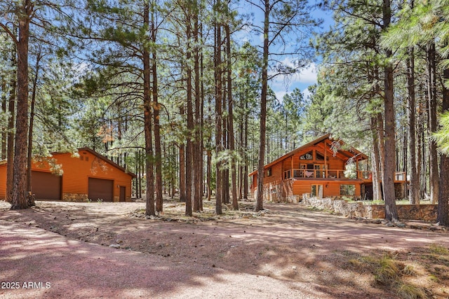 1868 Flicker Dr, Forest Lakes, AZ 85931 - view of front of home featuring stone siding, a detached garage, and an outdoor structure