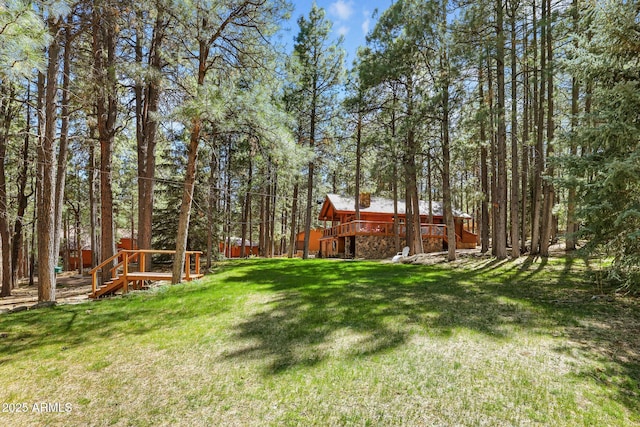 1868 Flicker Dr, Forest Lakes, AZ 85931 - view of green lawn featuring a wooden deck and a view of trees