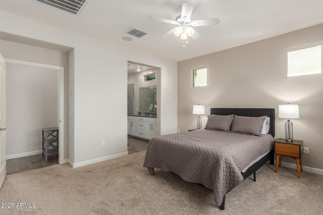 20783 W Pasadena Ave, Buckeye, AZ 85396 - carpeted bedroom with baseboards, ensuite bath, and a ceiling fan