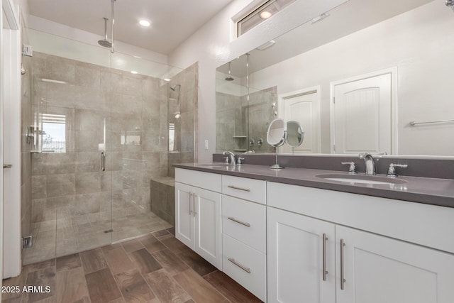 20783 W Pasadena Ave, Buckeye, AZ 85396 - full bathroom with double vanity, a shower stall, and wood finished floors