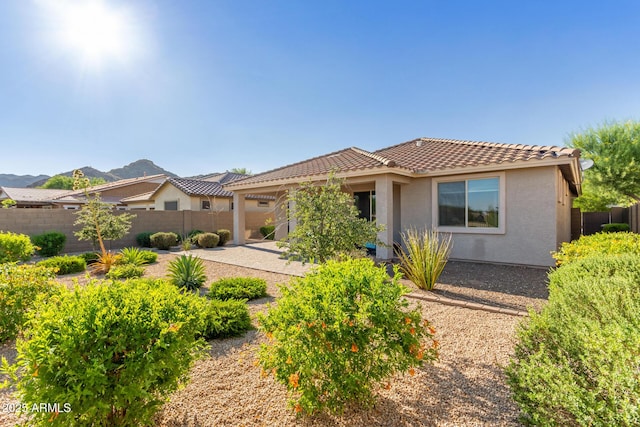20783 W Pasadena Ave, Buckeye, AZ 85396 - view of front of house with a tiled roof, stucco siding, and a mountain view