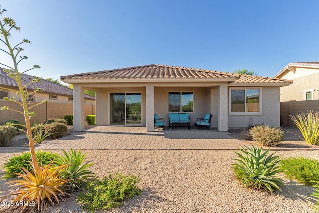 20783 W Pasadena Ave, Buckeye, AZ 85396 - back of property with stucco siding, a patio area, outdoor lounge area, and a tile roof