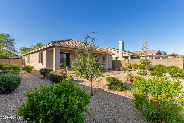 20783 W Pasadena Ave, Buckeye, AZ 85396 - back of house featuring stucco siding, a tiled roof, and a fenced backyard
