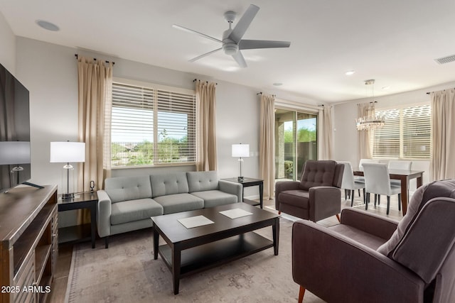 20783 W Pasadena Ave, Buckeye, AZ 85396 - living area with a chandelier, a ceiling fan, and healthy amount of natural light