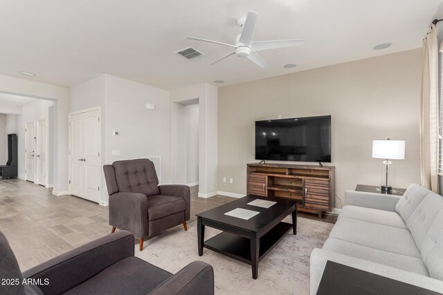 20783 W Pasadena Ave, Buckeye, AZ 85396 - living area with ceiling fan, baseboards, and light wood-style flooring