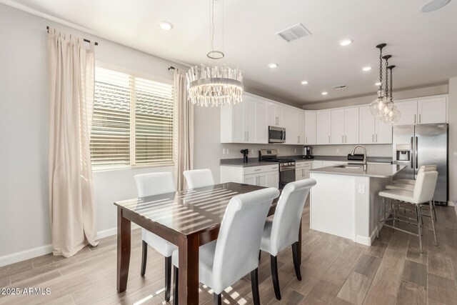 20783 W Pasadena Ave, Buckeye, AZ 85396 - dining area featuring light wood-style floors, a chandelier, recessed lighting, and baseboards