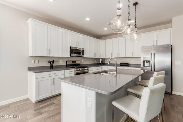 20783 W Pasadena Ave, Buckeye, AZ 85396 - kitchen with appliances with stainless steel finishes, a sink, recessed lighting, baseboards, and light wood-style floors