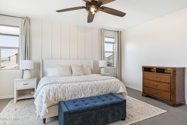 carpeted bedroom with baseboards and ceiling fan