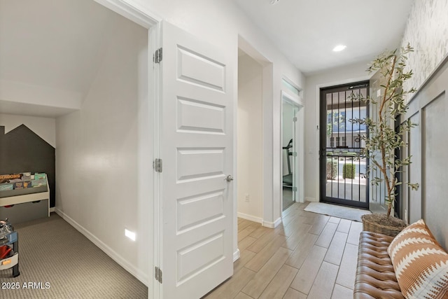 foyer with baseboards, light wood-style flooring, and recessed lighting