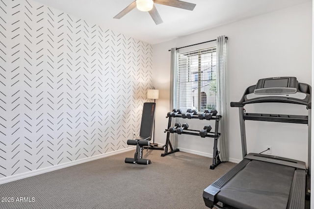 workout area with ceiling fan, carpet, baseboards, and an accent wall