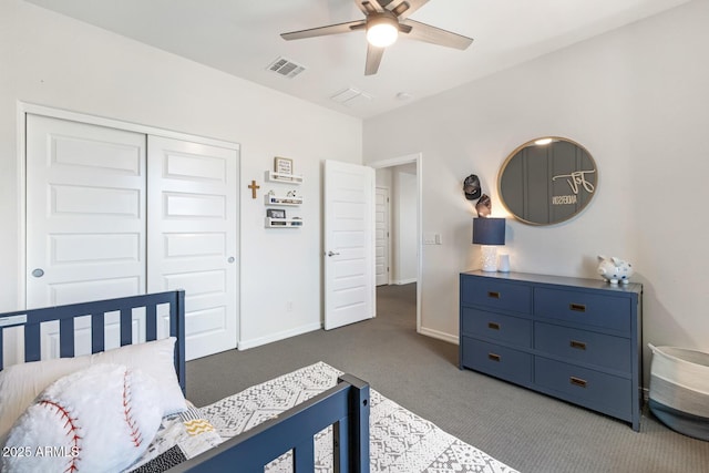 carpeted bedroom with a closet, baseboards, and ceiling fan