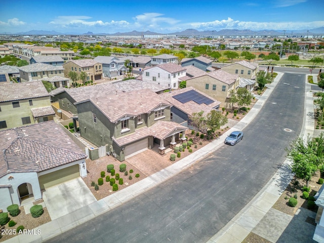 aerial view of residential area featuring a mountainous background