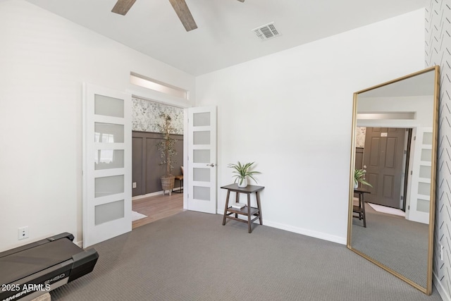 exercise room featuring carpet flooring, ceiling fan, french doors, and baseboards