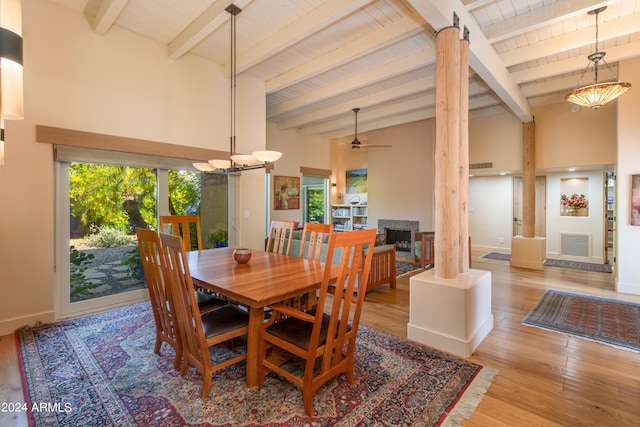 dining area with light hardwood / wood-style floors, beamed ceiling, wooden ceiling, ceiling fan, and decorative columns