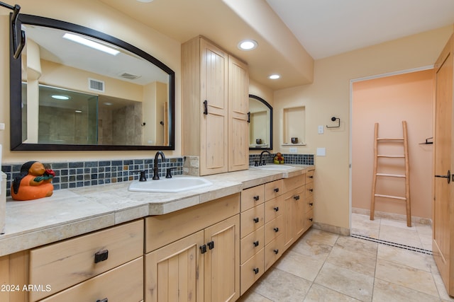 bathroom with tile patterned floors, an enclosed shower, vanity, and tasteful backsplash